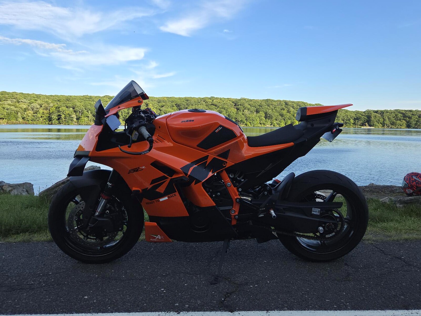 Orange KTM 990 RC R beside a lake