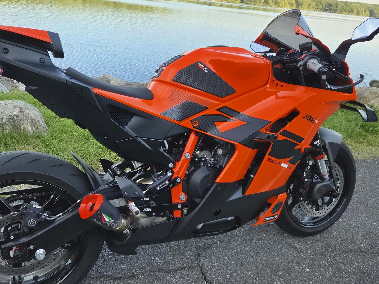 Three-quarter rear view of an orange KTM with lldesign side fairing decals