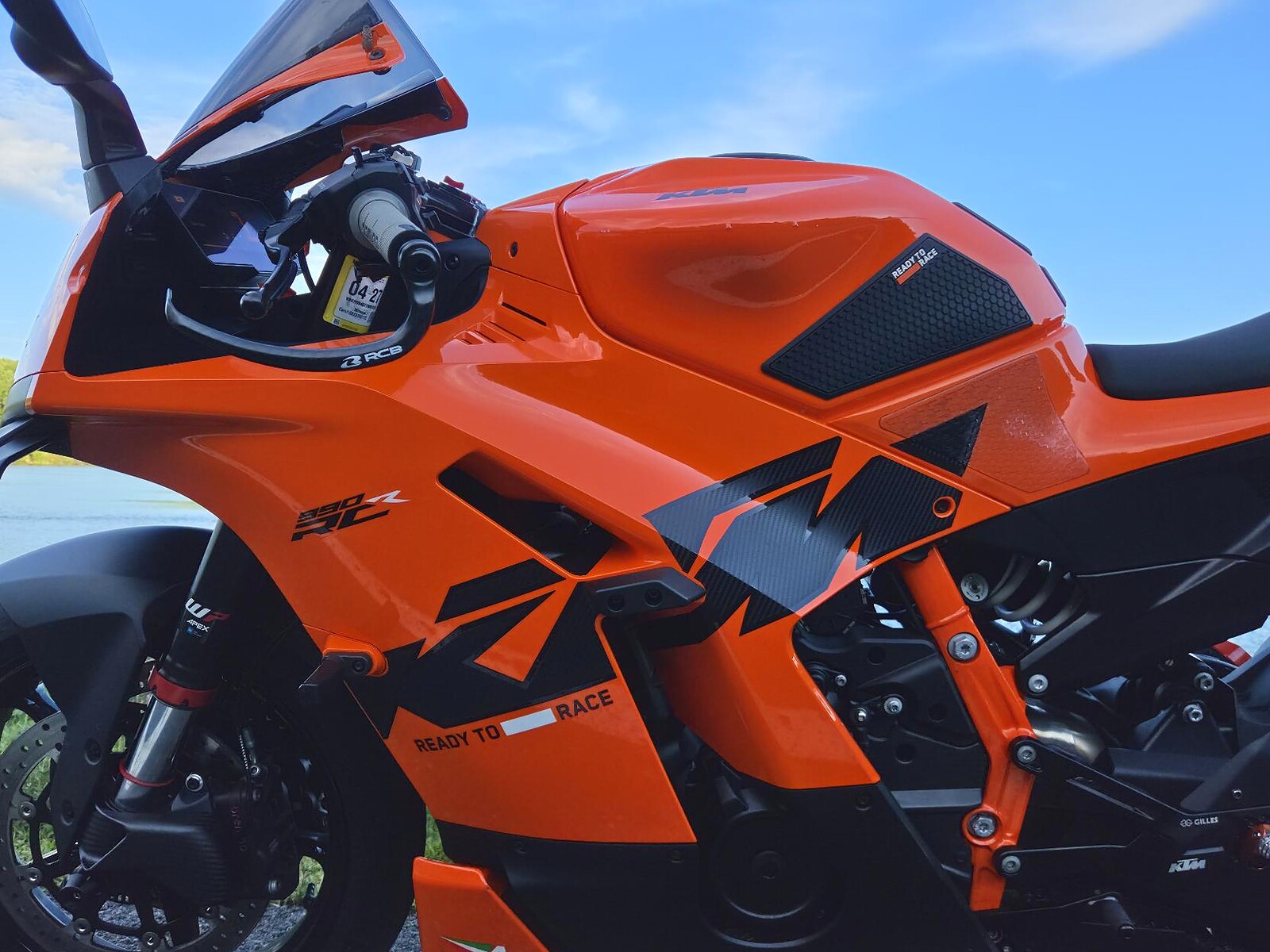 Close view of lldesign side fairing decals on an orange KTM